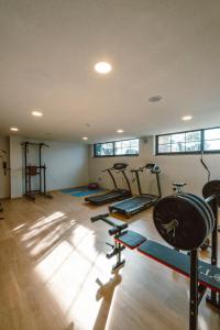 a gym with a bunch of treadms and cardio machines at Kosa Otel Çeşme in Çeşme