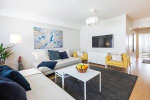 a living room with a couch and a table at City Holiday Apartments 1 in Rovaniemi