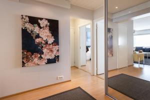 a living room with a large painting on the wall at City Holiday Apartments 1 in Rovaniemi