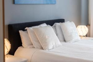 a bed with white pillows on top of it at City Home Rovakatu in Rovaniemi +10 photos