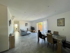 a large living room with a table and chairs at Case Di A Cappana-Villa CARLA in Bonifacio
