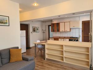 a kitchen and living room with a table and a couch at Apartament ANNA in Târgovişte