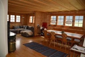 a living room with a table and chairs at Vesmira in Sedrun