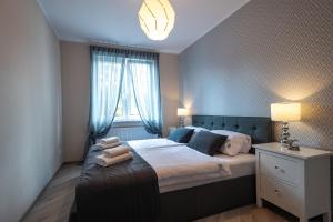 Postel nebo postele na pokoji v ubytování SnowApart w Villi Avangarda