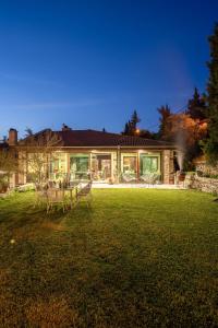 a house with a lawn in front of it at VILLA YANA Hotel Winery&Spa in Stara Zagora