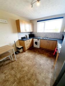 a small kitchen with a sink and a dishwasher at Rayleigh Town Centre 3 Bedroom Apartment in Rayleigh
