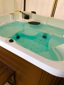 a bath tub filled with a greenuilt at Agriturismo Rocce Bianche - Bungalows in Arbus