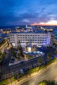 an aerial view of a building with a parking lot at Nestor Hotel in Ayia Napa