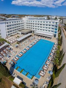an overhead view of a hotel with a swimming pool and chairs at Nestor Hotel in Ayia Napa