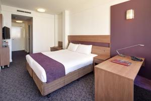 a hotel room with a bed and a desk at Quality Hotel Ambassador Perth in Perth