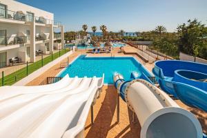 a large swimming pool with a water slide at Hotel Cabogata Jardín in Retamar