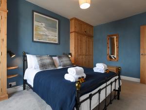 a bedroom with a bed with towels on it at Pass the Keys Modern Seafront Apartment With Great Views Sleeps 4 in Portsmouth