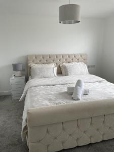 a large white bed with two white pillows on it at Castle View Chalet by Clonlum Cottages in Newry