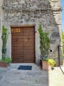 a wooden garage door in a stone building at La Tana del Riccio in Abbadia San Salvatore