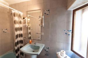 a bathroom with a sink and a shower at Pension Iberia in Llanes
