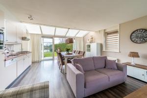 a kitchen and living room with a couch and a table at Antibes 232 - Kustpark Village Scaldia in Hoofdplaat
