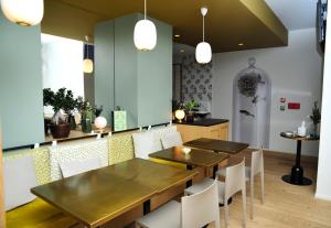 a dining room with two tables and white chairs at ibis Styles Paris Gare De Lyon TGV in Paris