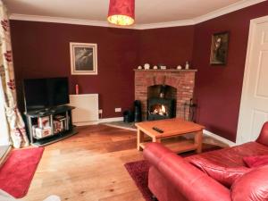 a living room with a couch and a fireplace at 5 Church View in Pickering