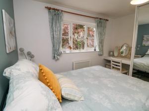 a bedroom with a large bed and a window at 5 Church View in Pickering