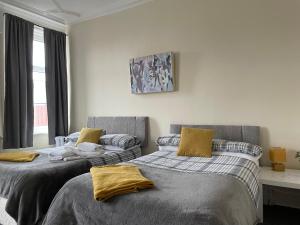 two beds sitting next to each other in a room at Dunes Hotel in Whitley Bay
