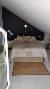 a bedroom with a large bed with a black headboard at Oriñon Beach Apartment in Oriñón