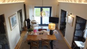a living room with a table and chairs at Casa da Ribeirinha in Ribeirinha