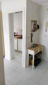 a kitchen with a table and a white floor at Oriñon Beach Apartment in Oriñón