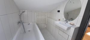 a white bathroom with a tub and a sink at Boutique hotel Lili in Rovinj