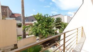 a stairway leading up to a building with a tree at Sardinianworld - Xenia Boutique in Oristano