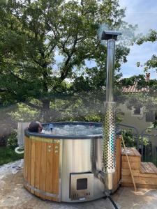 a hot tub with a fountain in a backyard at Gîte "Bois-Mariage" in Mollans-sur-Ouvèze