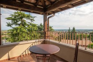 a table and chairs on a balcony with a view at Casa del Vicario in Fagagna