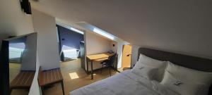 a bedroom with a bed and a desk in a room at Boutique hotel Lili in Rovinj