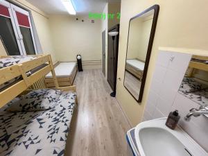 a room with a bed and a sink and a mirror at Noclegi - Helska OSTOYA - Hel Helska 11 in Hel +59 photos