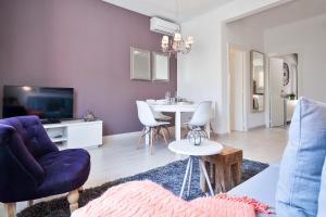 バルセロナにあるCharming & Quiet Park Guell Apartmentの紫色のソファとテーブル付きのリビングルーム