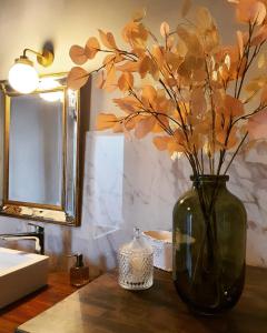 Bastelica的住宿－Casa Nanuccia，浴室里一个花瓶,桌子上放着鲜花