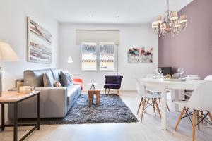 a living room with a couch and a table at Charming & Quiet Park Guell Apartment in Barcelona
