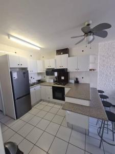 a kitchen with white cabinets and a refrigerator at Margate, Granada 303 in Margate +6 photos