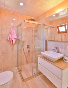 a bathroom with a shower and a sink and a toilet at Kuytu Kaş Houses in Kas