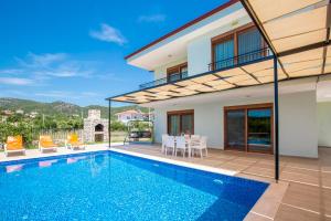 a villa with a swimming pool and a house at Kuytu Kaş Houses in Kaş