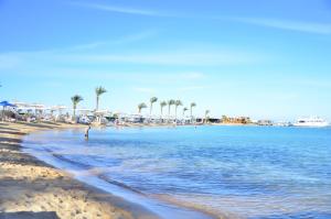 a beach scene with a body of water at Swiss Inn Resort Hurghada in Hurghada