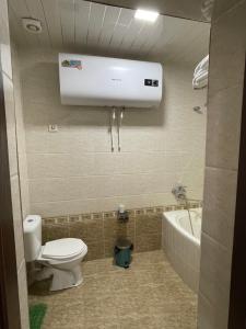 W łazience znajduje się toaleta, umywalka i wanna. w obiekcie Rudaki Hotel in Panjakent w mieście Panjakent