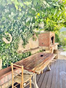 a wooden table and chairs in front of a green wall at Apartments Rome in Baška