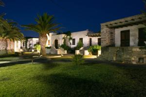 a house with palm trees in the yard at night at Sunset Pounda in Pounda