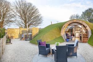 a igloo house with a table and chairs in the yard at The Charm Inn, The Little Burrow, Nr Wells in Radstock