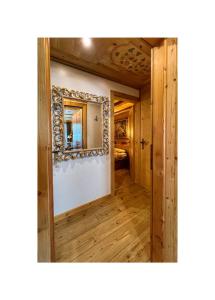 a view of a hallway with a mirror and a room at NONNA PINA Appartamento FIORI in Padola