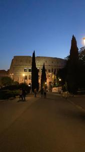 a large building with people walking in front of it at fabio rooms 102 in Rome