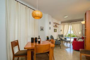 a dining room and living room with a table and chairs at Estrella 2 BA Spaniahome in Albir