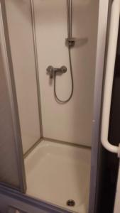 a shower with a hose in a shower stall at Kleine Unterkunft in Stuttgart-Münchfeld in Stuttgart