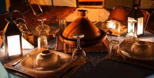 a table with a plate and pitchers on a table at Bivouac ZAGORA in Zagora +67 photos