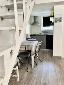 a kitchen with a table and chairs in a room at Apartments Rome in Baška